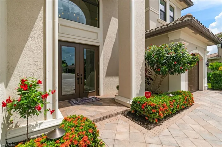 Newly refreshed colorful tropical landscape is meticulously maintained for stunning curb appeal entering up an expansive paver driveway between a split 3 car floorplan and soaring 2 story entry foyer.  The Modern exterior paint palette feels elegant and timeless with bright neutrals contrasted by rich browns.