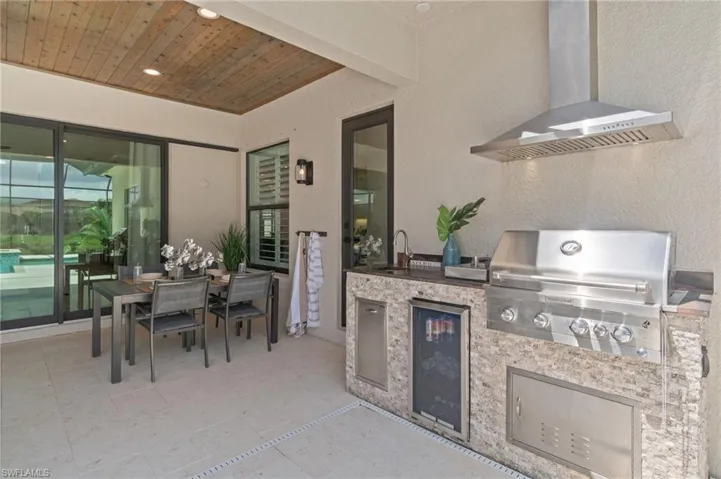 Detail view of the covered patio featuring an outdoor kitchen for year round grilling & outdoor dining.