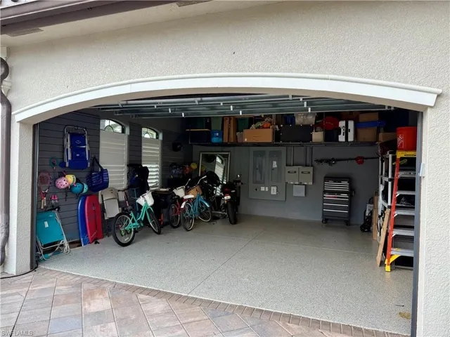 Expansive 2 bay main Garage features an electric vehicle charging panel, epoxy floors and built in BONUS wall storage across the back wall.Owner installed a 240 V outlet in the garage for any electric vehicle charging.