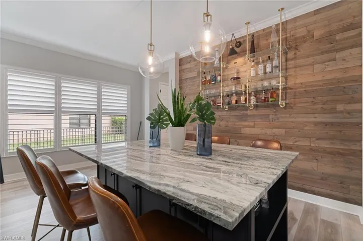 Quartz 6 person custom dining table with abundant storage and custom designer lighting.