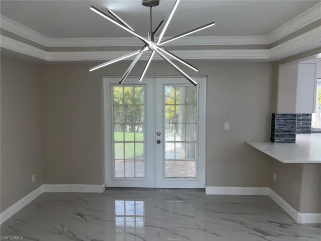 Dining Room with Crown Molding and Modern Lighting