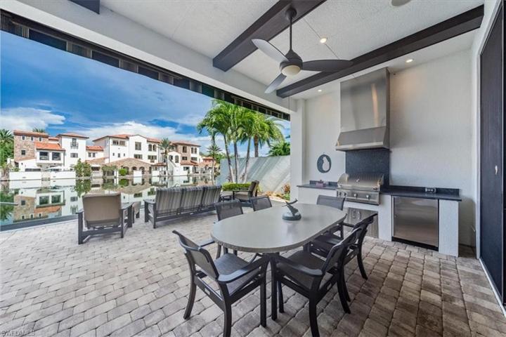 Summer kitchen with built-in gas grill, prep area, and beverage center