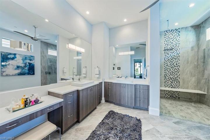 Primary Spa bath with dual vanities and oversized walk-in rain shower