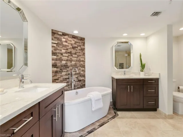Bedroom featuring wall-to-wall carpeting, a ceiling fan, and sliding glass doors with access to an outdoor space