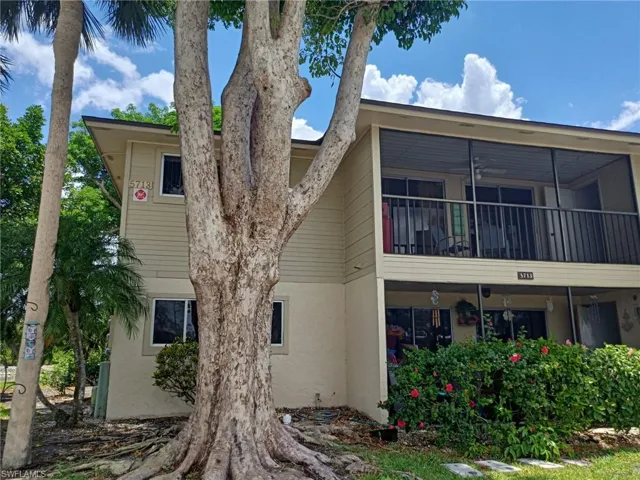 Rear view of property featuring stucco siding and a balcony