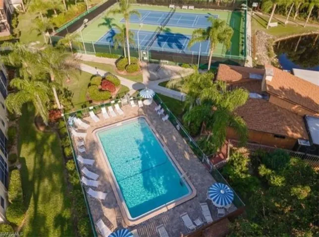Bird's eye view of a pool and a nearby body of water