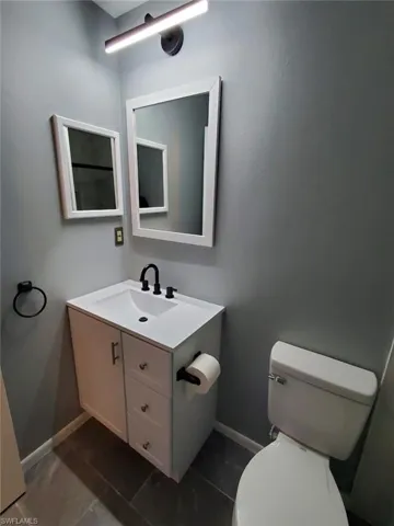 Bathroom featuring vanity and baseboards