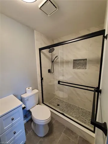 Bathroom with a shower stall and vanity