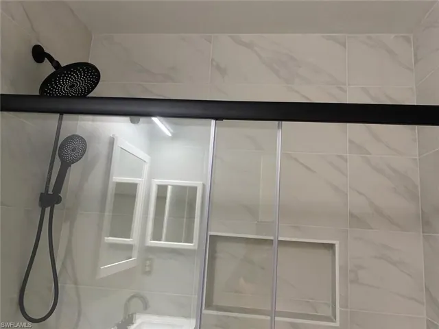 Full bathroom featuring tiled shower