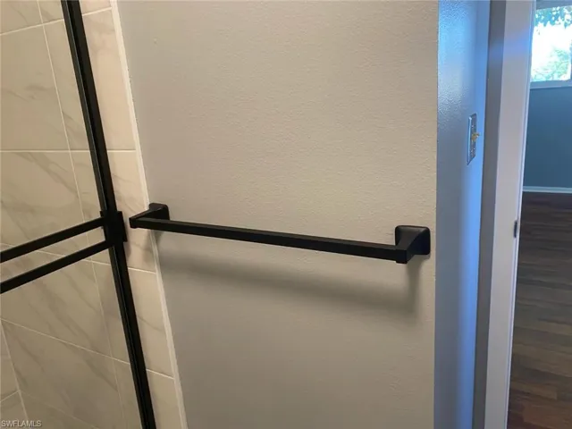 Detailed view of a textured wall and a shower with door