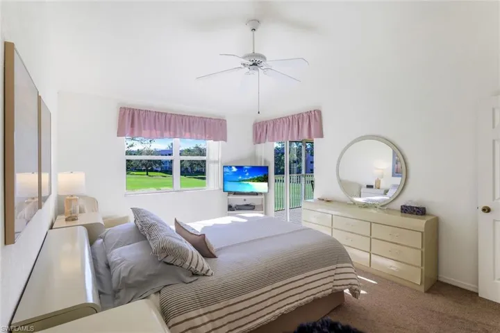 Bedroom featuring carpet flooring, a ceiling fan, and access to outside