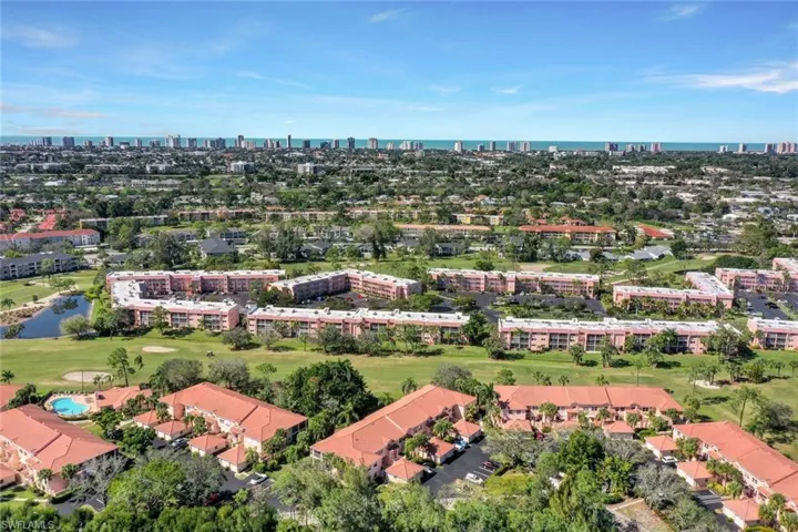 Aerial overview of property's location featuring a nearby body of water and skyline