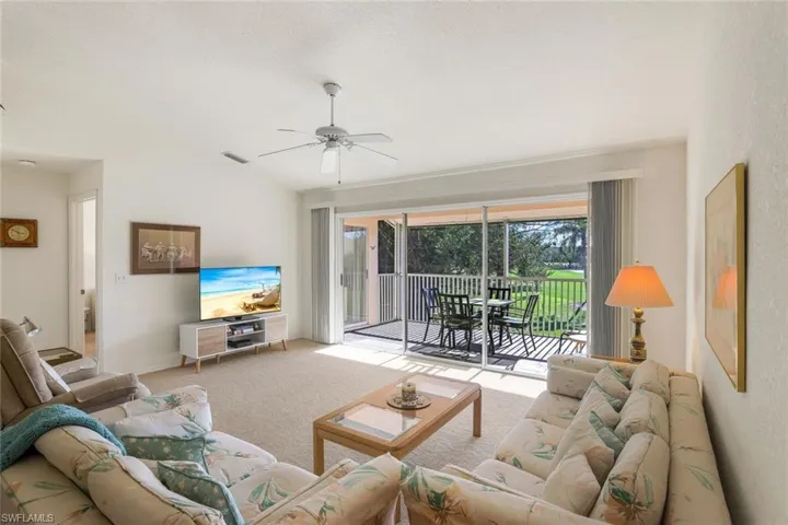 Living area with carpet and ceiling fan