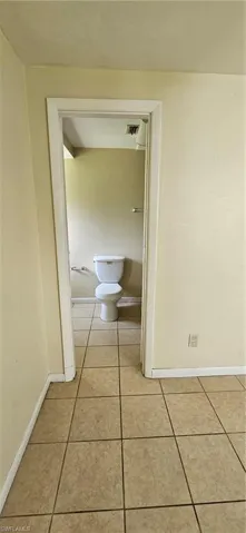 Hall featuring light tile patterned flooring