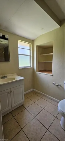 Bathroom featuring vanity, tile patterned flooring, and toilet