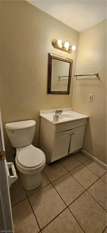 Bathroom featuring tile patterned flooring, vanity, and toilet