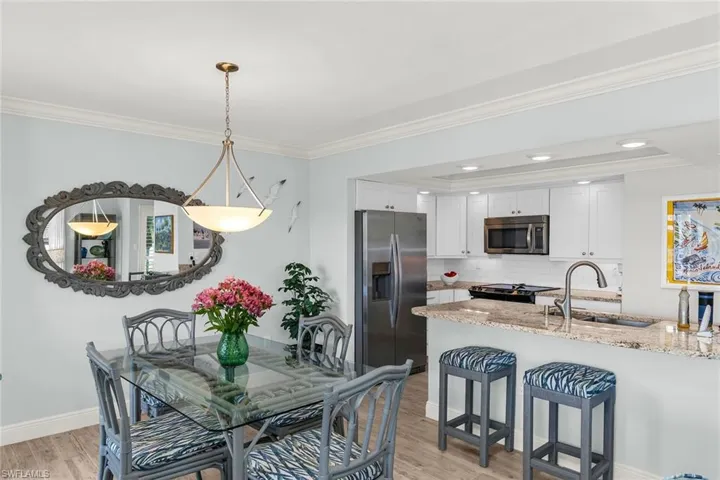 Dining space with recessed lighting, light wood-type flooring, baseboards, and ornamental molding