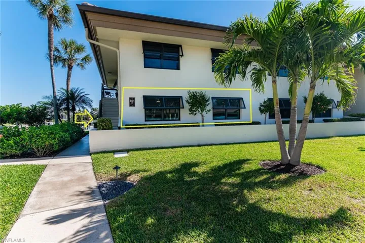View of front of home featuring a front lawn and stucco siding