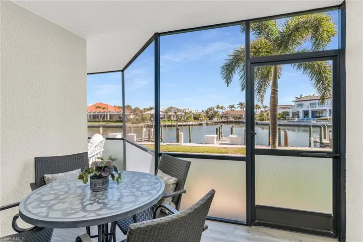Sunroom / solarium with a water view