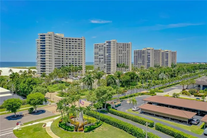 Aerial view featuring a city view and a water view