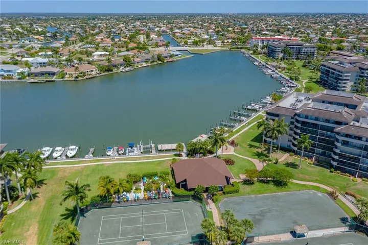 Birds eye view of property with a water view