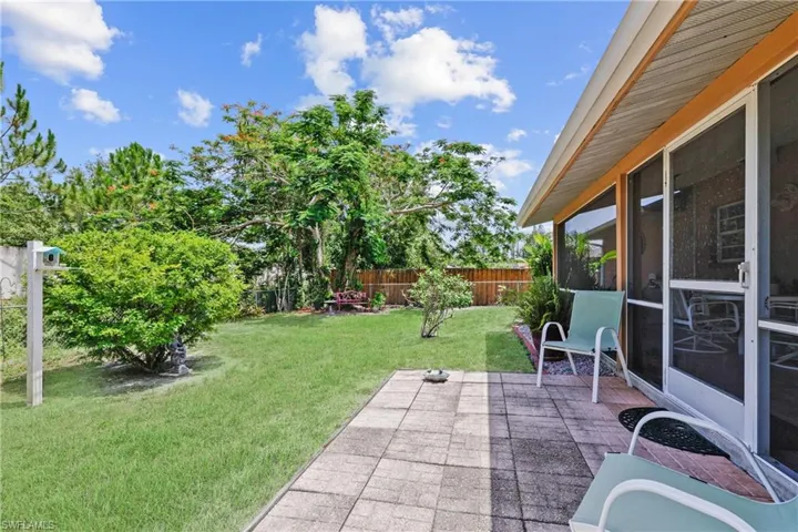 View of yard with a patio and a sunroom