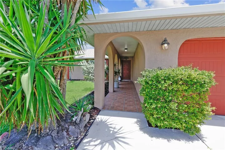 View of exterior entry featuring stucco siding