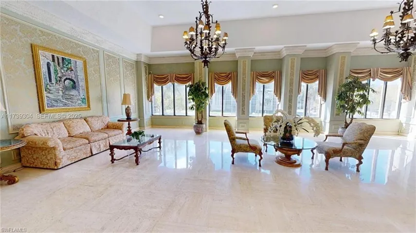Spacious interior featuring marble-finish flooring, high ceilings, decorative wall paneling, and multiple large windows with custom drapery