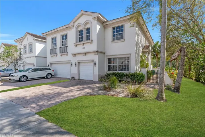 Mediterranean / spanish-style house with decorative driveway, an attached garage, stucco siding, and a front lawn