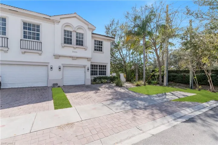 Mediterranean / spanish home with decorative driveway, stucco siding, a garage, and a front yard