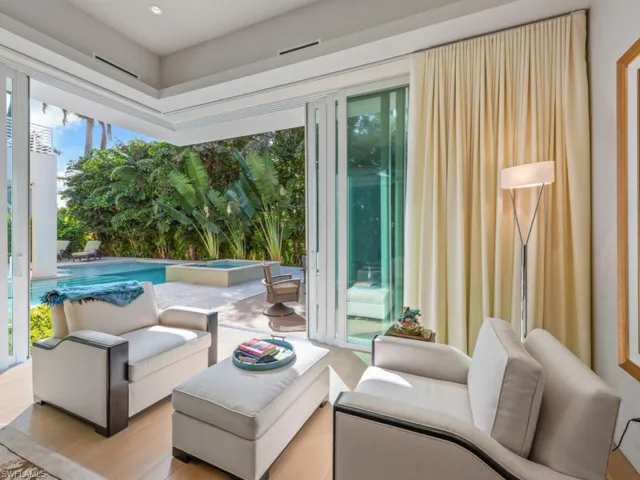Tranquil lounge in primary suite view to pool and spa