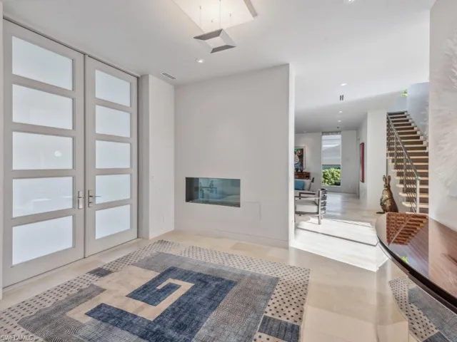 Foyer showing entry door detail and fireplace
