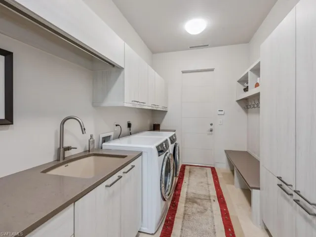 Laundry room with wall to wall storage cabinets