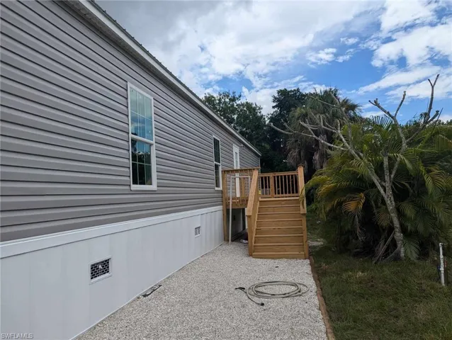 View of back side of home with a deck