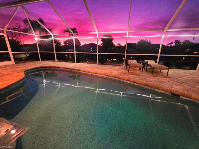 Swimming pool with a sunroom and a lanai