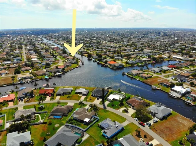 Aerial view of residential area featuring a large body of water