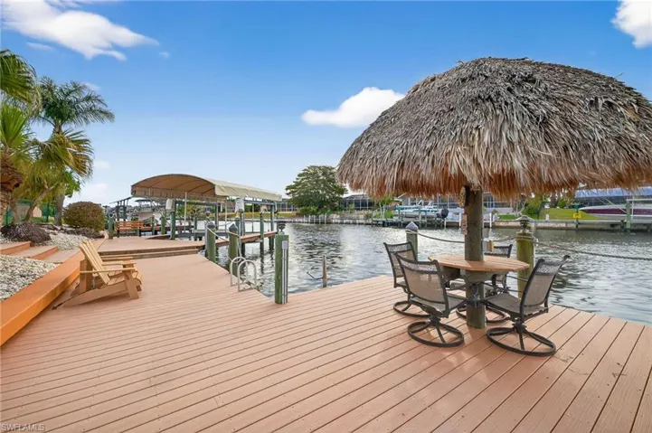 Dock featuring boat lift and a water view