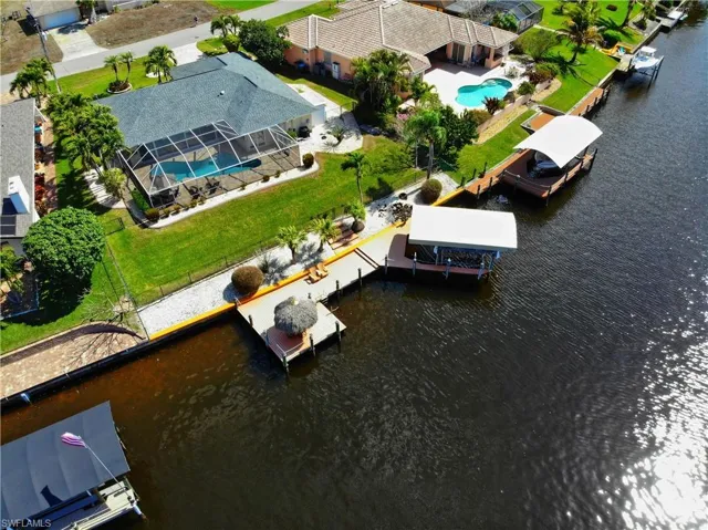 Bird's eye view of a nearby body of water and a pool area