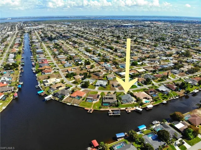 Aerial view of property's location featuring nearby suburban area and a nearby body of water