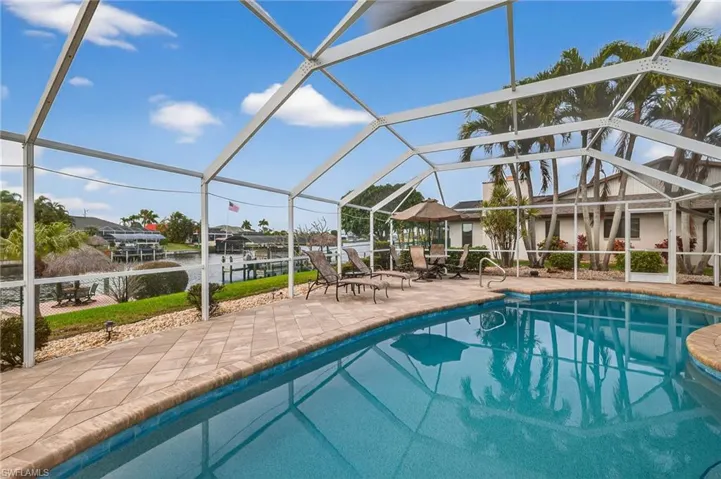 Outdoor pool with a sunroom, a lanai, and a patio