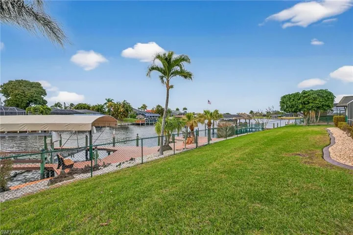 View of yard featuring boat lift, a boat dock, and a water view