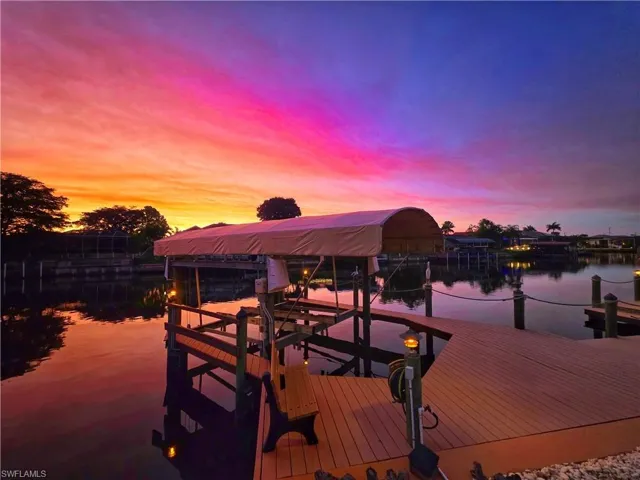 Dock area with boat lift and a water view