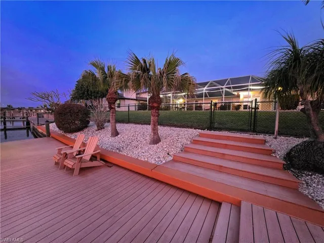 Wooden deck featuring a gate and a lanai