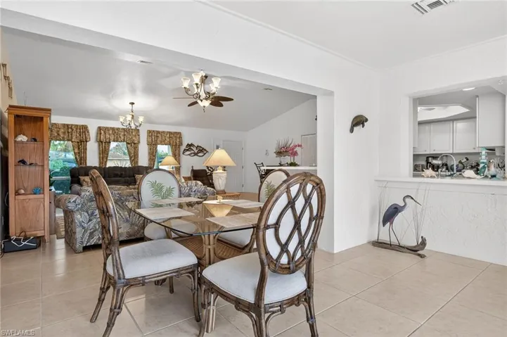 Dining room featuring hanging lights and light tile patterned floors