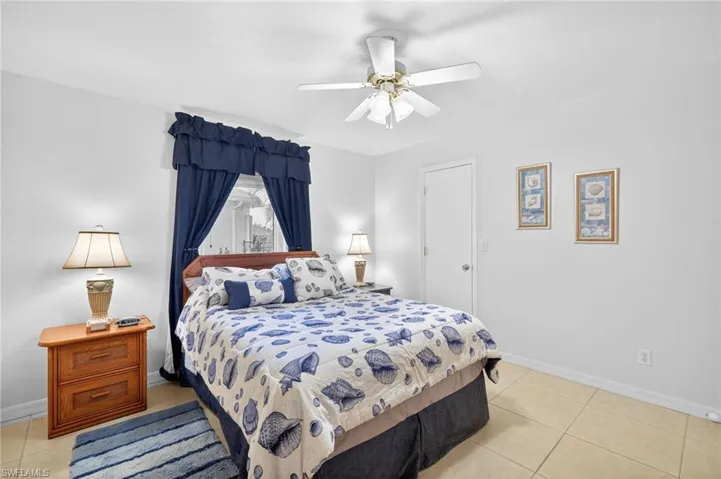Bedroom featuring light tile patterned floors and a ceiling fan