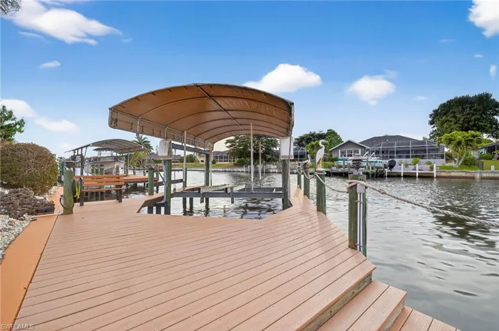 Dock area with boat lift and a water view