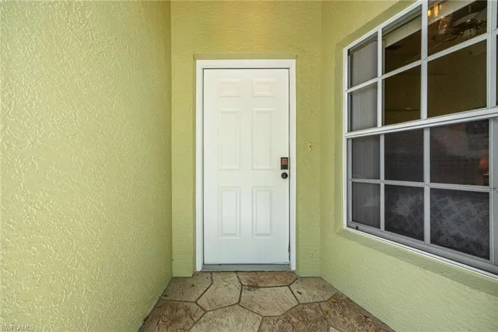 Property entrance featuring stucco siding