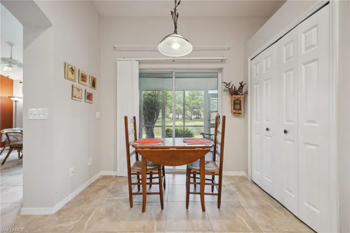 Dining space with light tile patterned floors and baseboards