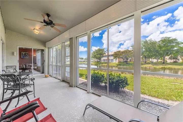 Sunroom / solarium featuring a water view and ceiling fan