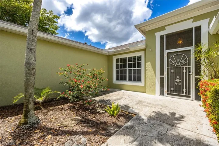 Entrance to property with stucco siding